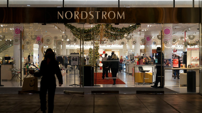 A security guard, right, stands at the entrance to a Nordstrom department store at the Grove mall in Los Angeles, Thursday, Dec. 2, 2021.(AP Photo/Jae C. Hong)