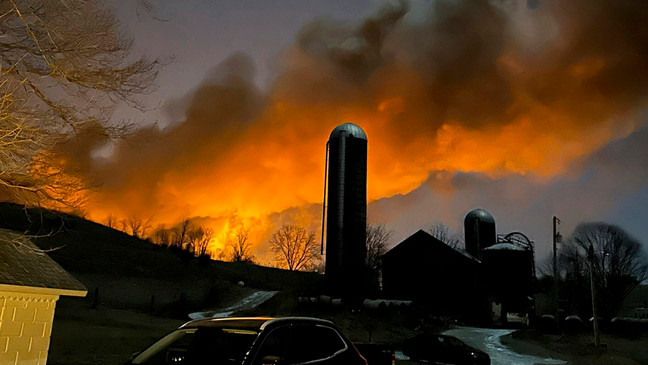 FILE - In this photo provided by Melissa Smith, a train fire is seen from her farm in East Palestine, Ohio, Friday, Feb. 3, 2023. (Melissa Smith via AP)