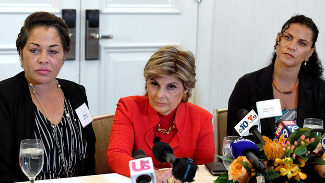FILE - Attorney, Gloria Allred, center, along with her clients, Chelan Lasha, left and Lise-Lotte Lublin, right, Bill Cosby accusers, takes questions from reporters during a press conference at the Le Meridien Hotel in Philadelphia, Pa., Sunday, Sept. 23, 2018.{&nbsp;} (Jose F. Moreno/The Philadelphia Inquirer via AP)